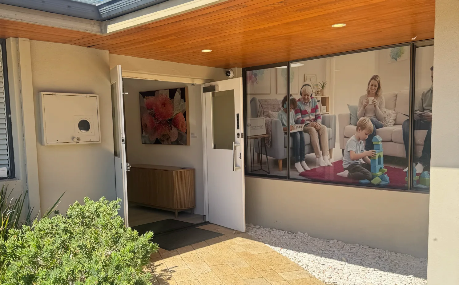 The front entrance of the Booragoon clinic, with a garden bed and an open door