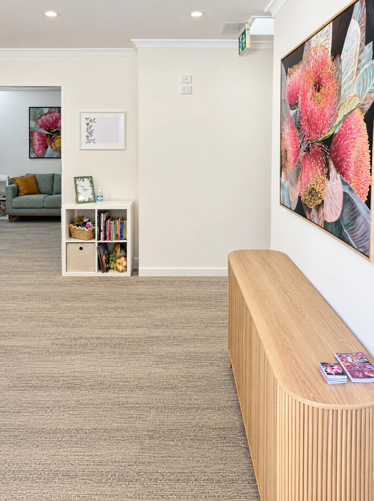 The Booragoon hallway with a curved timber sideboard and gum blossom artwork